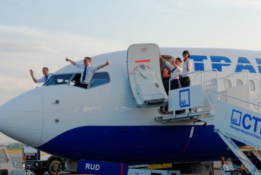 The crew of the Boeing-737 plane, the Transaero company, welcomes passengers at Strigino's airport in Nizhny Novgorod clipart
