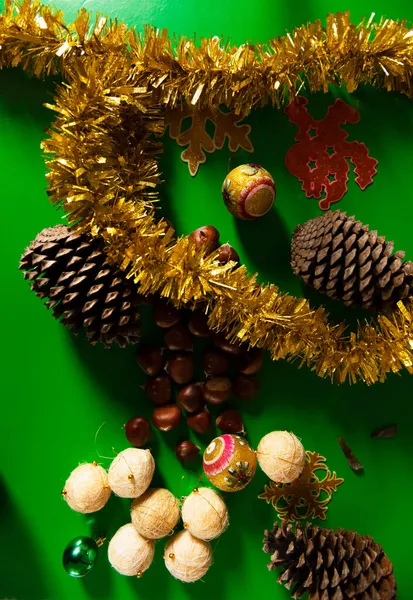 Decoration christmas with green background with chestnuts and pine cones. christmas and new year concept — Stock Photo, Image