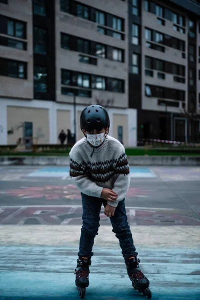 Caucasian boy practises roller skating in a city park — стоковое фото