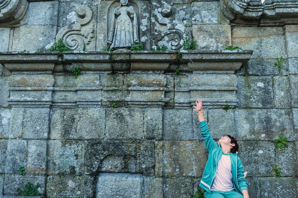 Portrait of a Caucasian boy at ancient stone wall — Stok fotoğraf