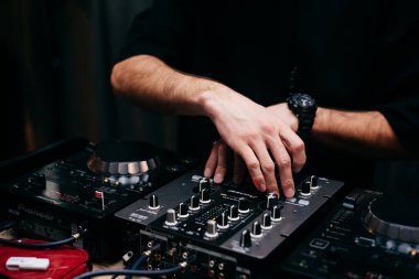 The DJs hand on the mixer. Dj on the turntables. hand on a mixer close-up. 