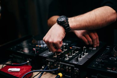 The DJs hand on the mixer. Dj on the turntables. hand on a mixer close-up. 