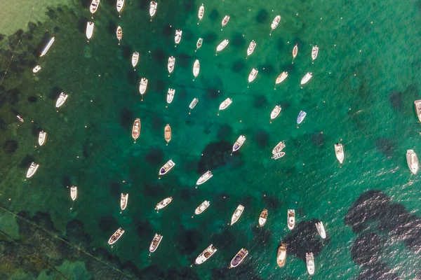 Aerial view of sailing and fishing boats docked in a small bay in Procchio near Marciana Marina, Elba Island, Italy.