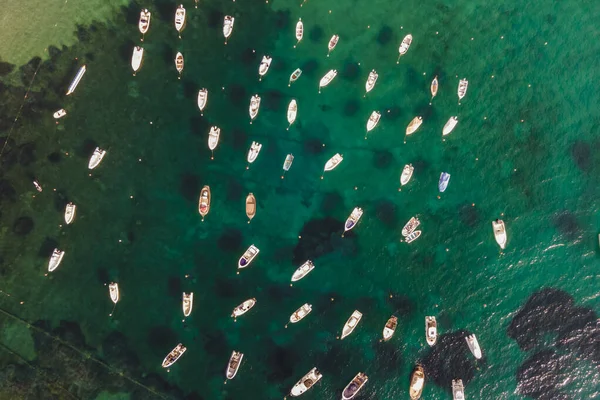 Aerial view of sailing and fishing boats docked in a small bay in Procchio near Marciana Marina, Elba Island, Italy.