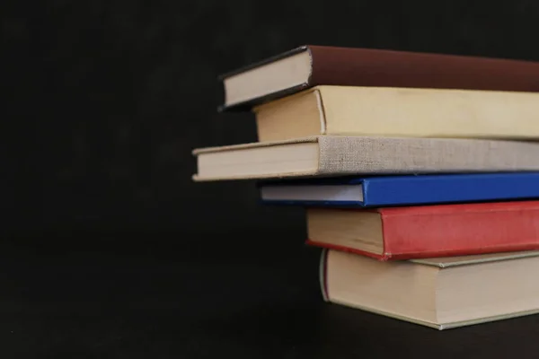 stock image Stack of books on black background