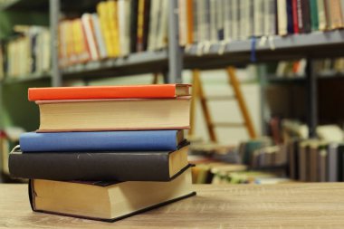 Kitaplar kütüphanede masanın üstünde.