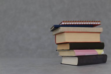 Gri arkaplan üzerine kitap yığını