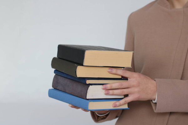 Books in hand on white background