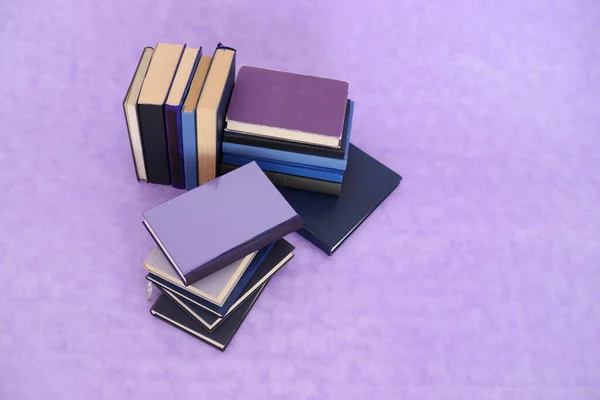 一摞书上紫色背景 — 图库照片