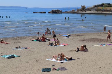 Split, Croatia, 14.05.2022.Nice and many tourists use the beautiful and sunny weather for sunbathing and swimming on the famous Split beach Bacvice