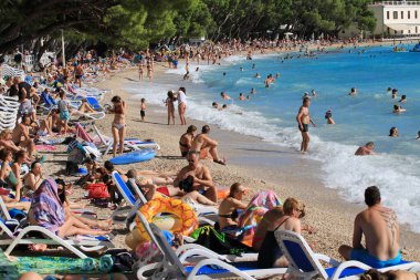 Makarska, croatia, 11.07. 2022.  Bathers on the beach in Makarska, a tourist resort in the south of Croatia