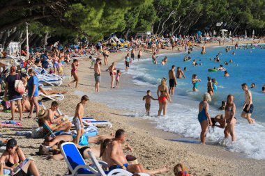 Makarska, croatia, 11.07. 2022.  Bathers on the beach in Makarska, a tourist resort in the south of Croatia