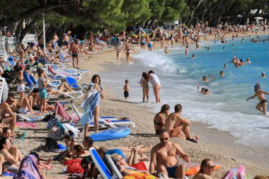 Makarska, croatia, 11.07. 2022.  Bathers on the beach in Makarska, a tourist resort in the south of Croatia