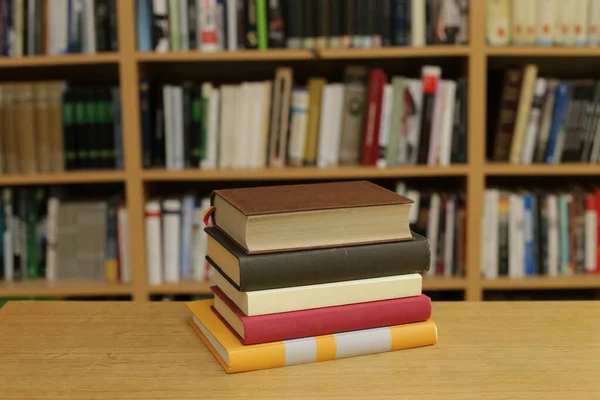 books and bookshelves on a wooden shelf.