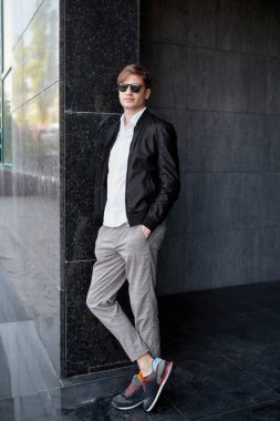 Güneş gözlüğü takan zarif, yakışıklı bir iş adamı..