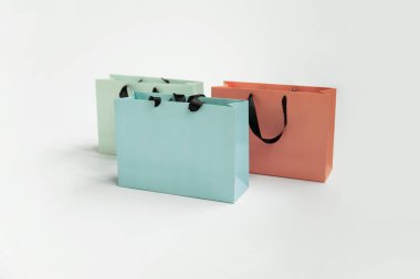 Mock-up of blank craft package, mockup of colored paper shopping bag with black handles on the white background