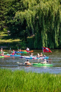 Wausau, Wisconsin, USA, July, 30, 2022: 8th Annual Paddle Pub Crawl on Lake Wausau and the Wisconsin River, Kayakers enjoying the Saturday, vertical