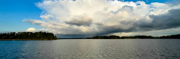 Rain clouds in the distance on Lake Nokomis in Tomahawk, Wisconsin, panorama