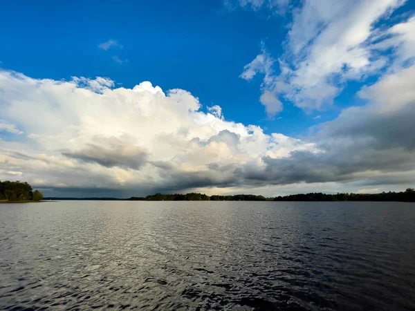 Rain clouds in the distance on Lake Nokomis in Tomahawk, Wisconsin, horizontal