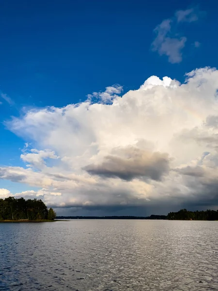 Rain clouds in the distance on Lake Nokomis in Tomahawk, Wisconsin, vertical