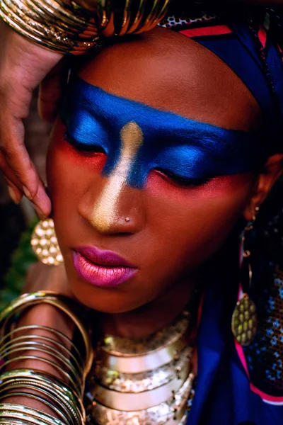 Beautiful black woman with color makeup with gold  ornamentation — Stock Photo, Image