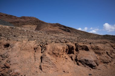 Sabah güneşinde lav dağı. Parlak mavi gökyüzü. Monatna Roja, Playa Blanca, Lanzarote, Las Palmas, Kanarya Adaları, İspanya.