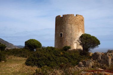 Sardinya 'nın güneyinde yer alan Torre di Pixinni adlı antik taş kulenin kalıntıları, Domus de Maria. Baharda bulutlu bir gün. Akdeniz adası Sardunya, İtalya.