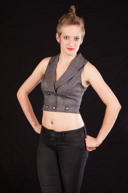 Pretty woman with her hands on her hips and a smile