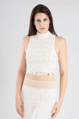 Beautiful woman in white outfit looking thoughtful 