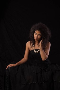 Pretty woman in a black dress looking thoughtful