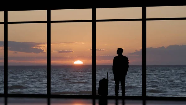 Man Suitcase Standing Panoramic Window Sea Sunset — Photo