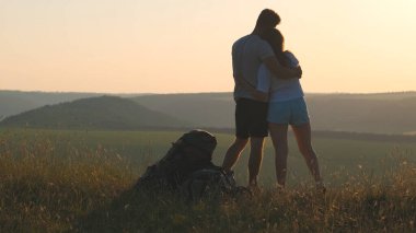 The romantic couple stand on the mountain top 
