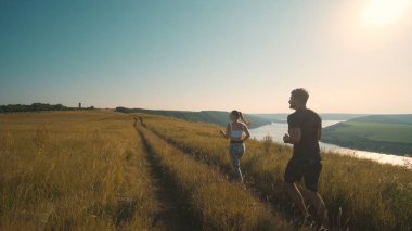 The man and woman running on a beautiful river background