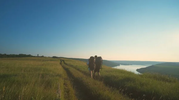 Two Travelers Walking Backpacks Blue Sky Background – stockfoto