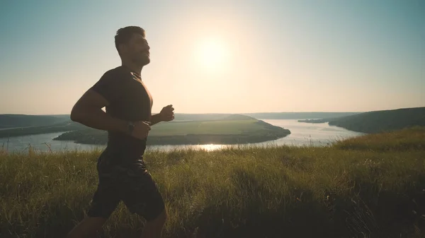 The man running on a beautiful river background