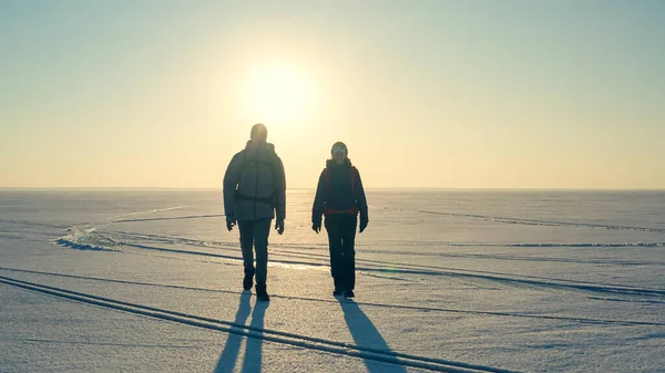 Two Expeditors Backpacks Walking Snow Field — Photo
