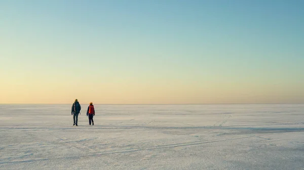 Two People Backpacks Walking Huge Snow Field – stockfoto