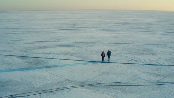Two People Backpacks Walking Huge Snow Field – stockfoto