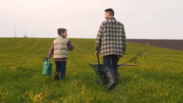 Farmer His Son Walking Field – stockfoto