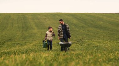 The father and son are going to work at the field