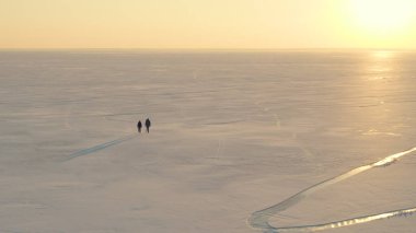 The beautiful view on the snow field and walking expeditors