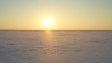 The beautiful sunset view over the endless snow field