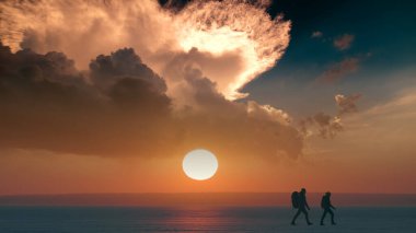 The romantic couple walking through the snow field on sunset background