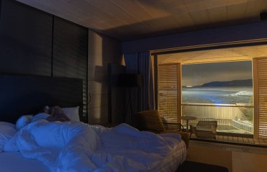 The man and woman have rest in the bedroom with a beautiful view