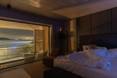 The man and woman have rest in the bedroom with a beautiful view