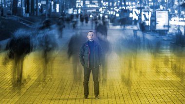 The man stands in the street on a ukrainian flag background