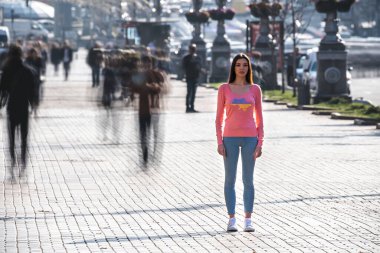 The ukrainian woman stands in the middle of crowded street