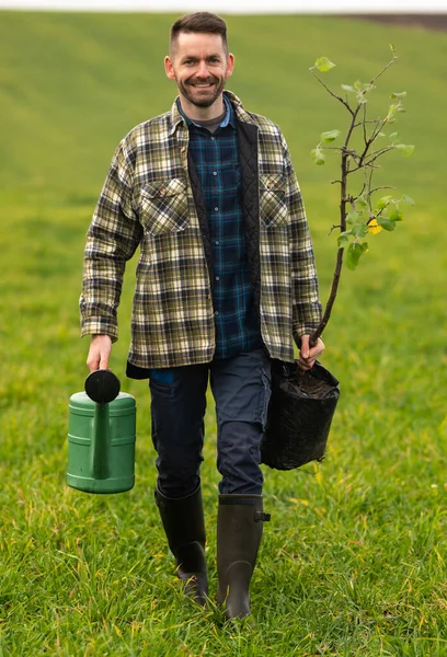 Handsome Man Going Plant Tree Field — kuvapankkivalokuva