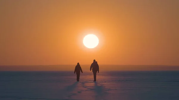 Man Woman Going Snow Field Sunset Background – stockfoto