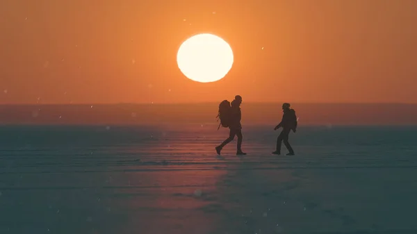 Romantic Couple Walking Snow Field Sunset Background – stockfoto